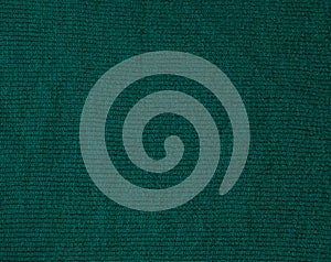 Dark green background from a textile material. Fabric with natural texture. Cloth backdrop