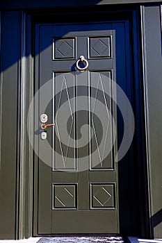 Dark green painted wooden door with golden knob
