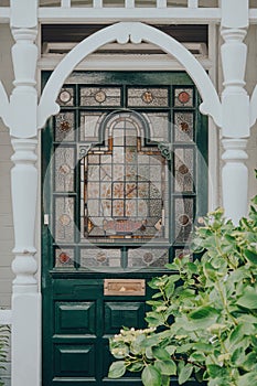 Dark green stained glass door of an Edwardian house in London, UK