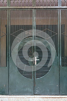 Dark green steel door with line and circle form in Hanoi, Vietnam