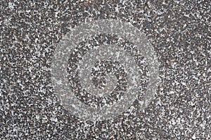 Dark grey asphalt pavement texture with small rocks