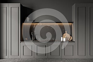 Dark grey kitchen with illumination and marble splashback