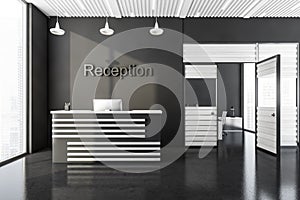 Dark grey reception area of international legal office, front desk