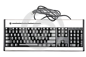 A dark grey and silver colored computer wired keyboard