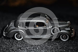 Dark grey vintage car . Retro car`s close up.Retro car on a dark background. Car close-up