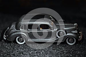 Dark grey vintage car . Retro car`s close up.Retro car on a dark background. Car close-up