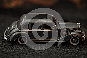 Dark grey vintage car . Retro car`s close up.Retro car on a dark background. Car close-up