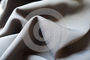 Dark grey viscose and polyester fabric in soft folds