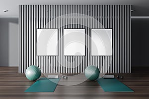 Dark gym interior with sport equipment and three mockup frames