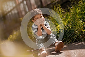 Dark-haired boy sitting and feeling lonely