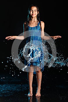 Dark-haired brown-eyed teenage girl posing in a black aqua-zone.