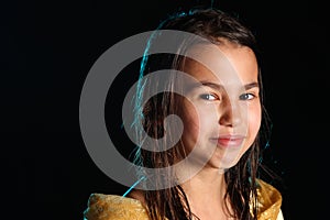 Dark-haired brown-eyed teenage girl posing in a black aqua-zone.