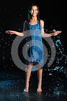 Dark-haired brown-eyed teenage girl posing in a black aqua-zone.