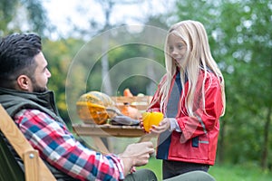 A dark-haired man and his daughter spending time on a farm