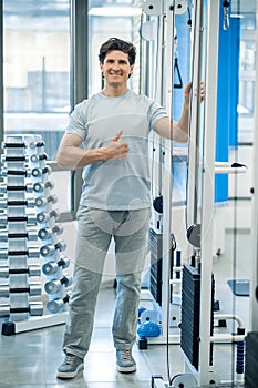 Dark-haired smiling physical therapist looking confident