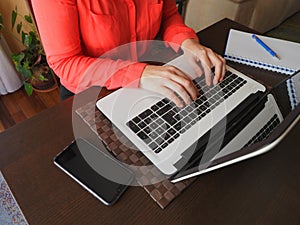 Dark-haired woman with curls teleworking at home