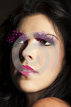 Dark haired woman wearing fantasy pink makeup
