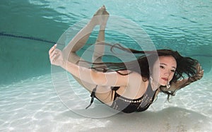 A dark haired women model in various outfits underwater