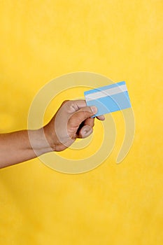 40-year-old Latino man shows his credit or debit card happy to use it in discounts and promotions in store and online purchases photo