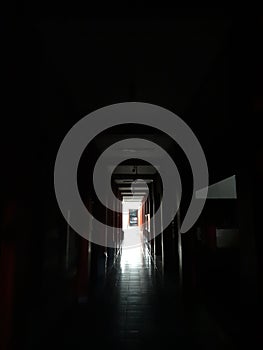 a dark hallway at a night and a lamp