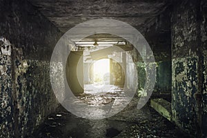 Dark hallway with peeling paint on the walls in an abandoned building