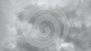 Dark, heavy clouds blanket the sky, dimming the light. A gray, somber scene hints at possible rain.