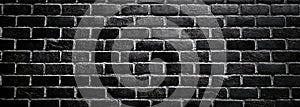 Dark, high-contrast, brick-textured, light-effect black brick wall