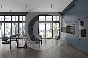 Dark home kitchen interior with dining and cooking area, panoramic window