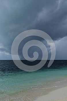 Dark hurricane cloud above tropical sea