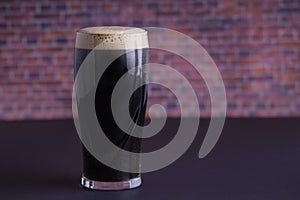 A dark Irish dry stout beer glass that originated in the brewery in dublin photo