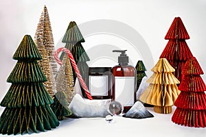 dark jar with lid and dispenser on the background of Christmas decorations, side view