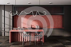 Dark kitchen interior with bar countertop and seats, cooking area