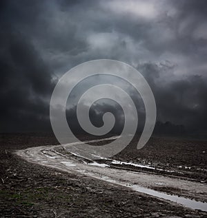 Dark Landscape with Dirty Road and Moody Sky