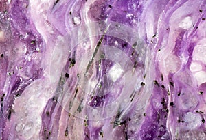 Dark and light lilac waves in charoite texture