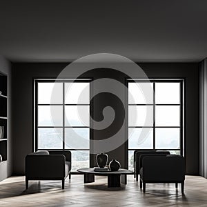 Dark living room interior with armchairs and sofa, bookshelf and window