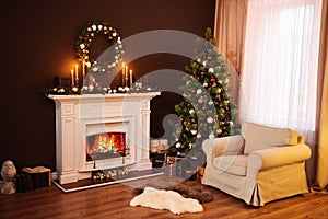 Dark living room interior with comfortable armchair next to the fireplace decorated