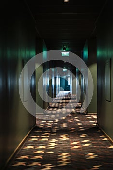 Dark corridor with light at the end inside a building