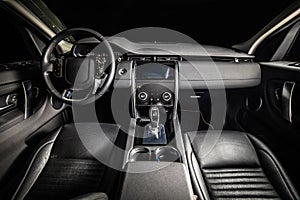 Dark luxury car Interior. Front seats of premium suv Leather panels. the view from the ceiling