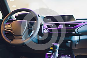 Dark luxury car Interior - steering wheel, shift lever and dashboard.