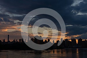 Dark Manhattan Skyline Silhouette along the East River during Sunset in New York City