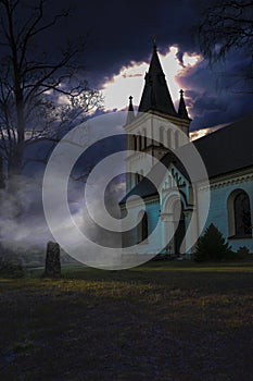 Dark Misty Spooky image of an old Swedish cemetery with its church