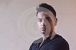 Dark moody portrait of cool young turkish man with spiky hair