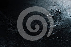 Dark moody underwater rock surface texture.