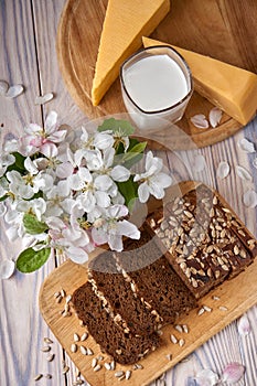 Dark multigrain bread made from rye, wheat, oats and barley with sunflower and flax seeds. Milk, cheese, apple tree flowers and