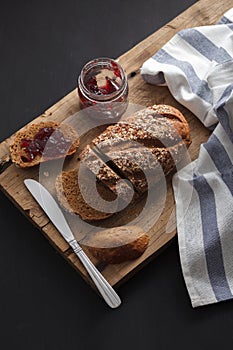 Dark multigrain bread whole grain and jam fresh baked on rustic