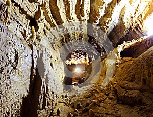 Dark mystery stone cave with light photo