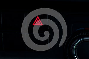 dark night. car dashboard on it emergency warning sign