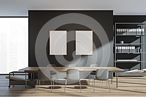 Dark office interior with two empty white posters, panoramic window