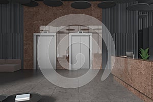 Dark office lobby interior elevators and marble reception desk with pc computer