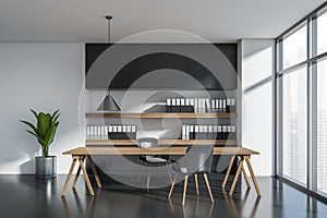 Dark office room interior with two armchairs, table, shelves